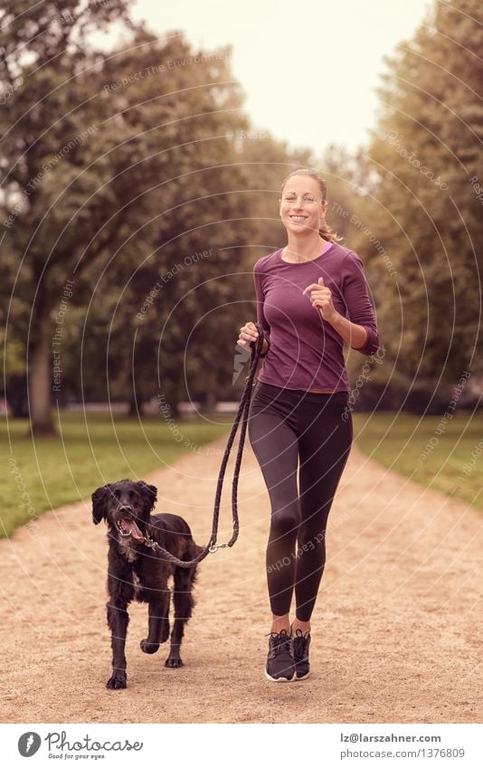 Healthy Woman Jogging in the Park with her Dog Lifestyle Relaxation Summer Sports Adults Friendship Animal Lanes & trails Pet Fitness Smiling Together Sunset
