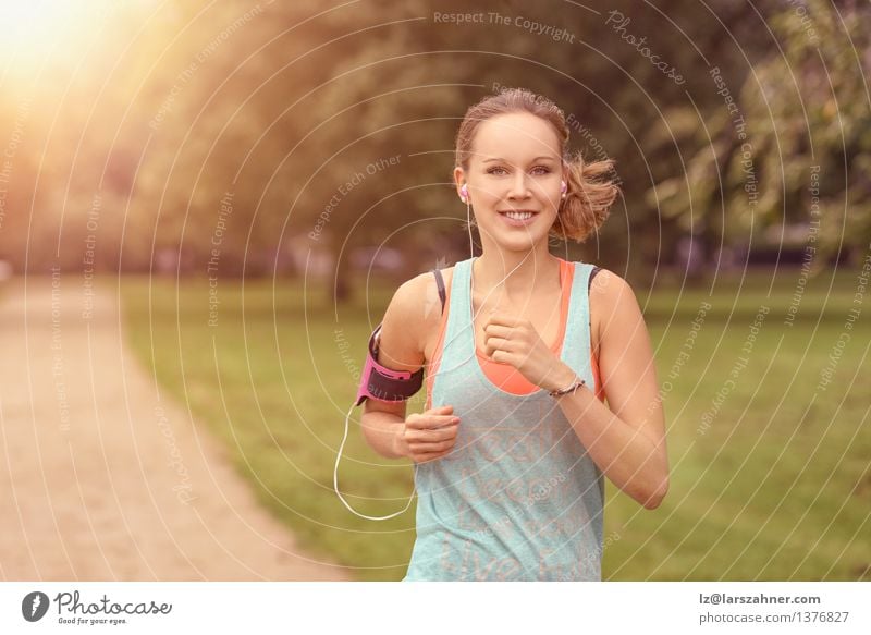 Pretty Woman Jogging at the Park with Headphones Lifestyle Happy Summer Music Sports Adults Landscape Autumn Leaf Street Movement Fitness Listening Smiling