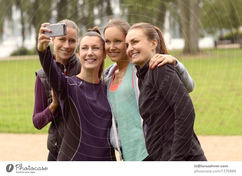Happy Women Taking Selfie After Outdoor Exercise Leisure and hobbies Summer Sports Telephone PDA Camera Technology Woman Adults Friendship Group Grass Park
