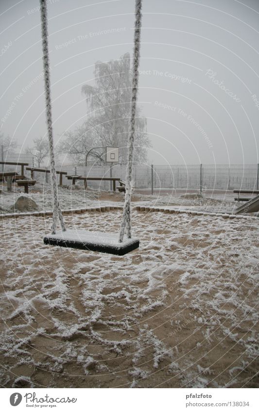Lonely swing Playground Swing Hoar frost Winter mood Traffic infrastructure Snow Weather Landscape Fog.