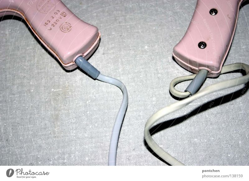 Two pink hairdryers of the same model lie next to each other. Vintage, voltage, electricity. The past. Pair Style already Hair and hairstyles Bathroom