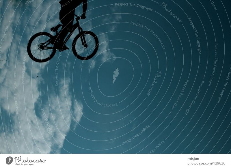 Headless E.T. Bicycle Jump Trick Stunt Shows Clouds Man Motorcyclist Mountain bike Reckless Risk Air Stand Dangerous Turquoise Summer Bird Superman Black