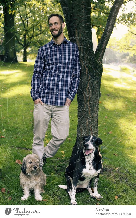portrait³ Trip Adventure Young man Youth (Young adults) Plant Beautiful weather Tree Park Checkered Brunette Short-haired Pet Dog 2 Animal Smiling Laughter