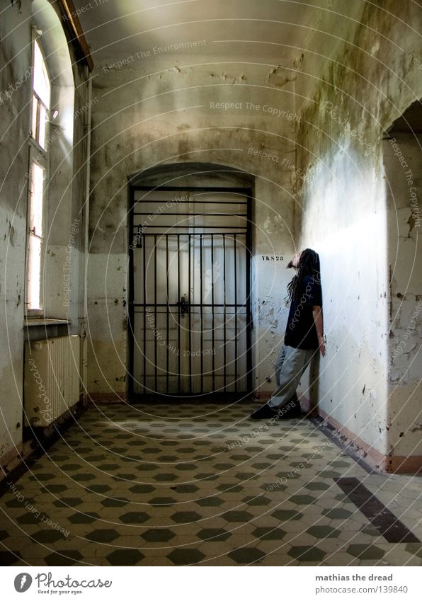 ray of hope Hallway Gate Grating 1 Person Individual Isolated (Position) Loneliness Captured Convict Penitentiary One young adult man Only one man Boredom