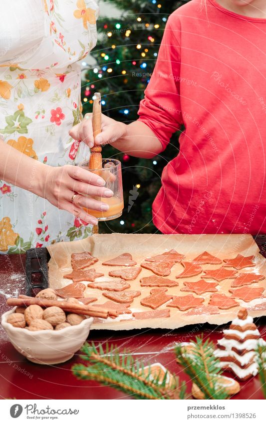 Mom with daughter making the Christmas cookies Table Kitchen Human being Girl Woman Adults Hand 2 8 - 13 years Child Infancy 30 - 45 years Make Cut Cutter Knife