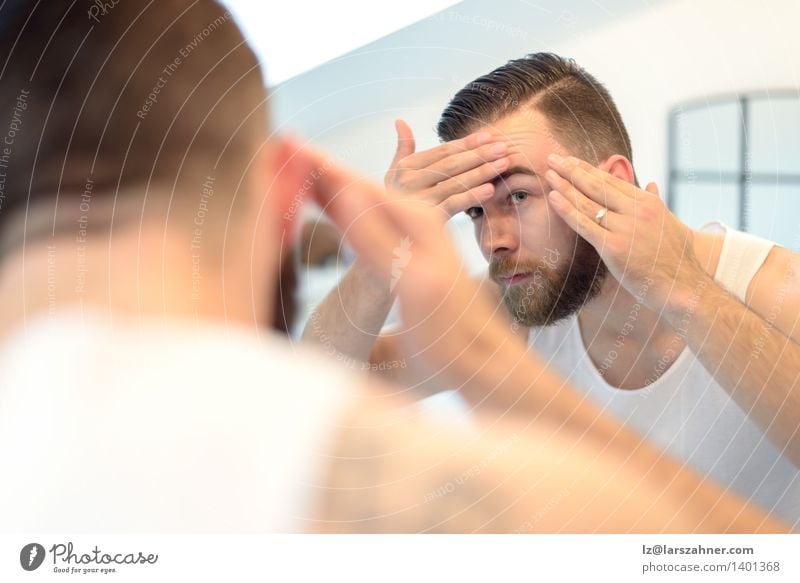 Bearded man checking his complexion Skin Face Mirror Bathroom Man Adults Hand Old Clean appearance cleanliness Complexion Conceptual design concerned Forehead