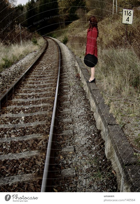 116 Freedom Woman Adults Nature Autumn Forest Platform Railroad tracks Coat Hat Stone Red Loneliness Reunion Forget Station Colour photo Subdued colour