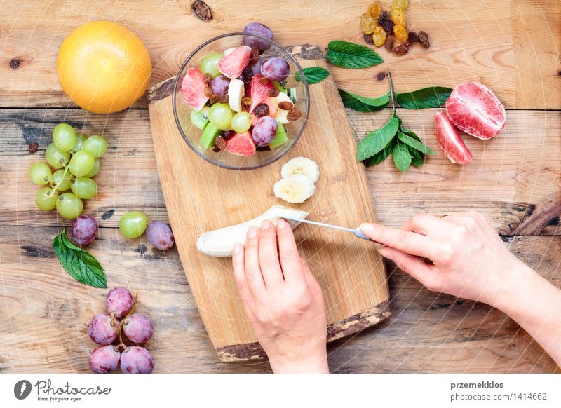 Making salad with fresh fruits Food Vegetable Fruit Lunch Vegetarian diet Diet Table Woman Adults Hand 1 Human being Wood Simple Fresh Bright Delicious Clean