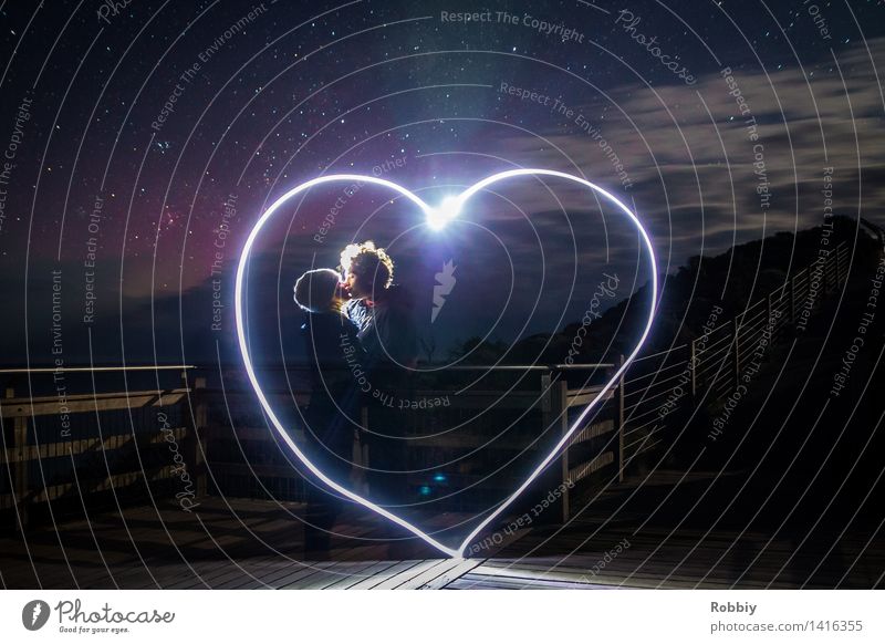 young couple kissing inside light painting heart Couple Partner Kissing Illuminate Together Happy Kitsch Emotions Spring fever Love Infatuation Romance