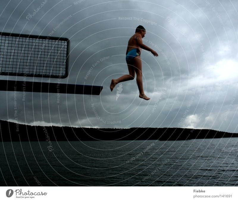 jumpers Jump Springboard Boy (child) Child Stride Air Rain Gray Storm Clouds Lake Swimming pool Open-air swimming pool Health Spa Swimming & Bathing Hop Sky