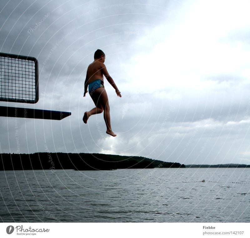 ready for the Olympics? Jump Springboard Boy (child) Youth (Young adults) Child Stride Air Rain Gray Storm Clouds Lake Swimming pool Open-air swimming pool