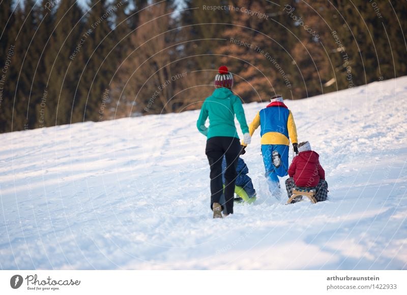 Family in winter Joy Leisure and hobbies Tourism Trip Winter Snow Winter vacation Human being Masculine Feminine Child Boy (child) Young woman