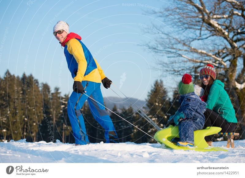 Family in winter Joy Athletic Tourism Trip Winter Snow Winter vacation Sleigh Human being Masculine Feminine Child Young woman Youth (Young adults) Young man