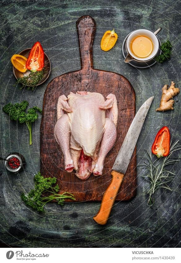 Whole chicken on old cutting board with ingredients Food Meat Vegetable Herbs and spices Cooking oil Lunch Dinner Banquet Organic produce Diet Bowl Knives