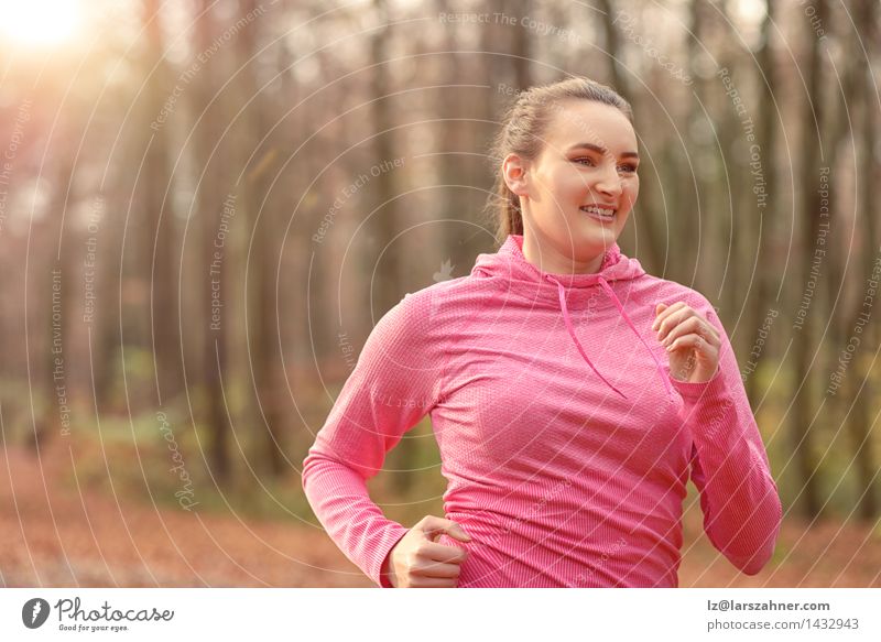 Pretty fit young woman jogging in woodland Diet Lifestyle Body Face Sports Jogging Woman Adults Nature Autumn Forest Brunette Fitness Smiling Fresh athletic