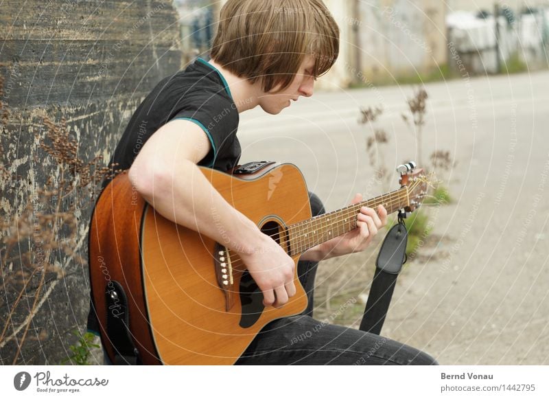 Young man with guitar Human being Masculine Youth (Young adults) 1 18 - 30 years Adults Emotions Moody Guitar Music Make music Sing Sit wood Acoustic