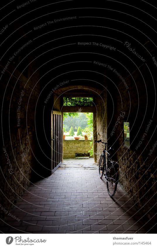 Bicycle in house passageway Old Tunnel Castle Perspective Way out Courtyard Garden Castle yard Wall (barrier) Block Goal door Vantage point Endurance
