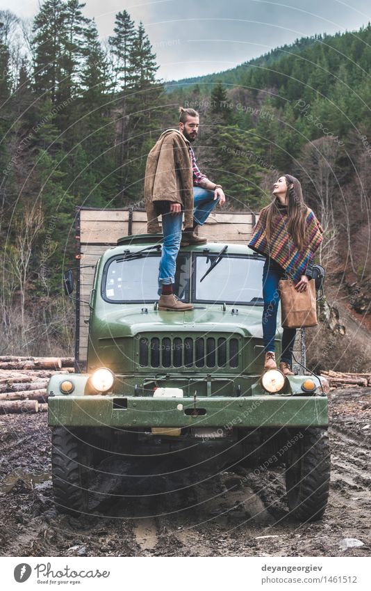Young man and girl on truck Lifestyle Vacation & Travel Trip Adventure Woman Adults Man Couple Forest Car Fashion Leather Hat Beard Old Log people pick young