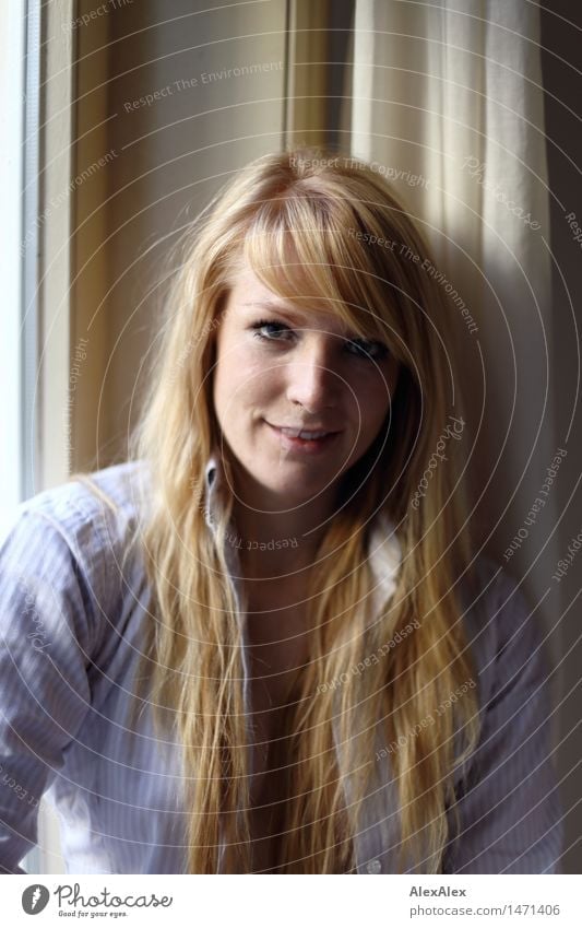 Portrait of a young blonde woman at a window pretty Harmonious Well-being Flat (apartment) Young woman Youth (Young adults) Hair and hairstyles Face