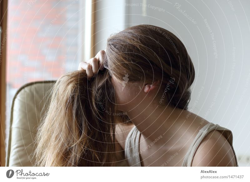 Young woman holds her long brunette hair into a long pony in front of her face Lifestyle pretty Personal hygiene Hair and hairstyles Youth (Young adults)