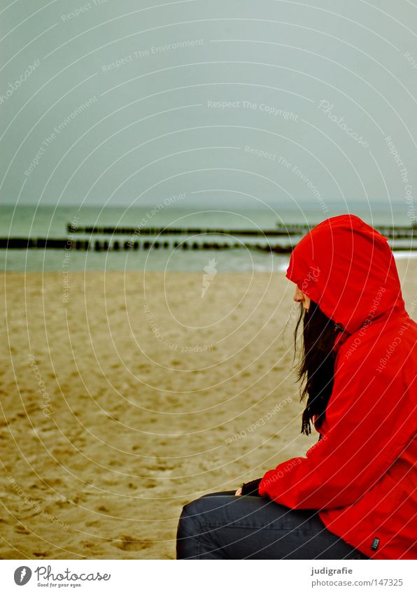 Red on the beach Beach Human being Woman Rain jacket Autumn Sand Coast Ocean Vacation & Travel Relaxation Cold Loneliness Think Hair and hairstyles Scarf