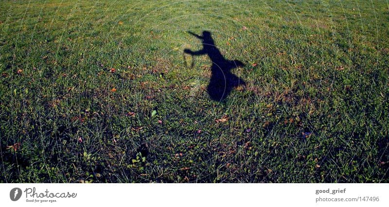 to cut a caper Jump Hop Meadow Field Man Child Childish Grass Sunlight Autumn Blur Joy jumping around frisk Shadow Human being Boy (child) camera strap Legs Arm