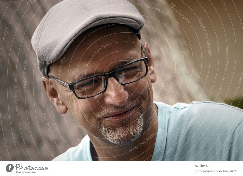 Bearded man with glasses and a cap smiles mischievously Masculine Man Adults Head Face Summer Eyeglasses Hat sliding cap Peaked cap Facial hair Smiling Brash