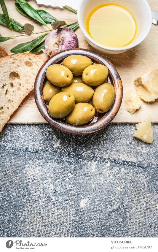 Olives in a bowl with baguette, oil and cheese Food Vegetable Bread Herbs and spices Cooking oil Nutrition Lunch Organic produce Vegetarian diet Diet