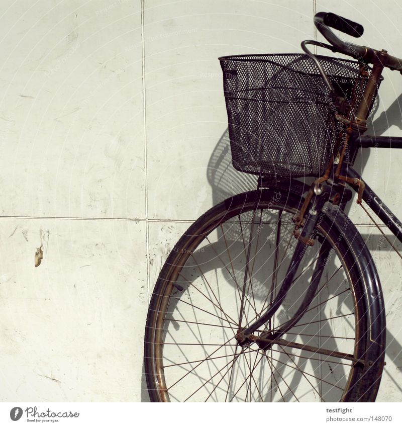 turned off Bicycle In transit Wall (building) Basket Light Transport Lean Parking bicycle basket Shadow