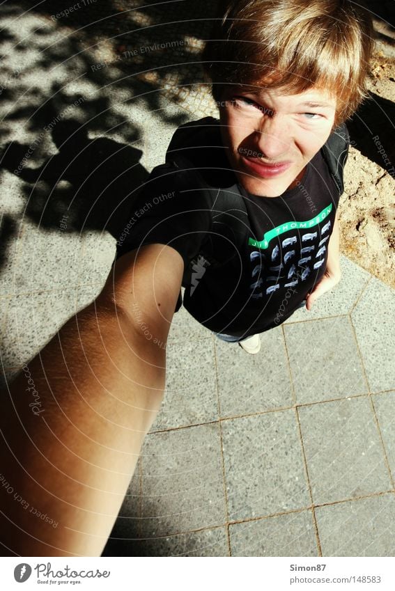 bizarre Above Lanes & trails Human being Perspective Wide angle T-shirt Arm Light Shadow Sidewalk Funny Facial expression Bird's-eye view Beautiful weather