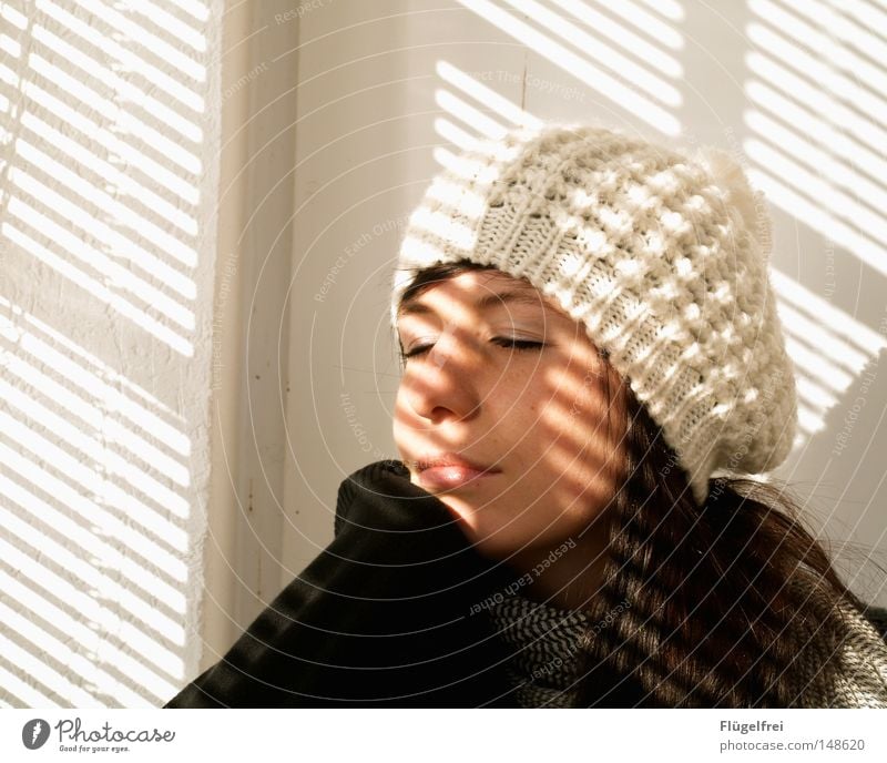 The last rays of the sun Hair and hairstyles Contentment Sun Sunbathing Woman Adults Arm Autumn Warmth Scarf Cap Stripe To enjoy Dream Cold White Romance