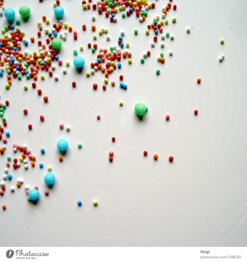 many small colourful sugar balls on a white background Sphere Round Roll Decoration Embellish Jewellery Delicious Sweet Sugar Blue Cyan Green White Red Yellow