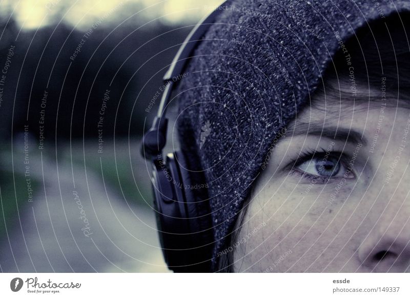digressed Colour photo Exterior shot Copy Space left Twilight Deep depth of field Looking Looking away Lifestyle Face Relaxation Music Headphones Feminine Skin