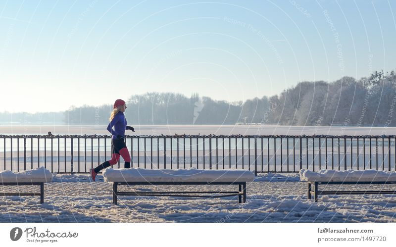 Young woman running in winter Lifestyle Ocean Winter Snow Sports Woman Adults 1 Human being 30 - 45 years Weather Lake Fitness Cold White Action athletic attire