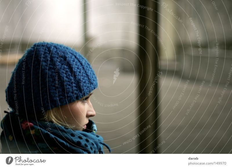 Still in the Hall Blonde Blue Cap Woman Feminine Scarf Cold Winter Think Looking Beautiful Cheek Left Wait Human being has Nose eyes Warehouse Beie