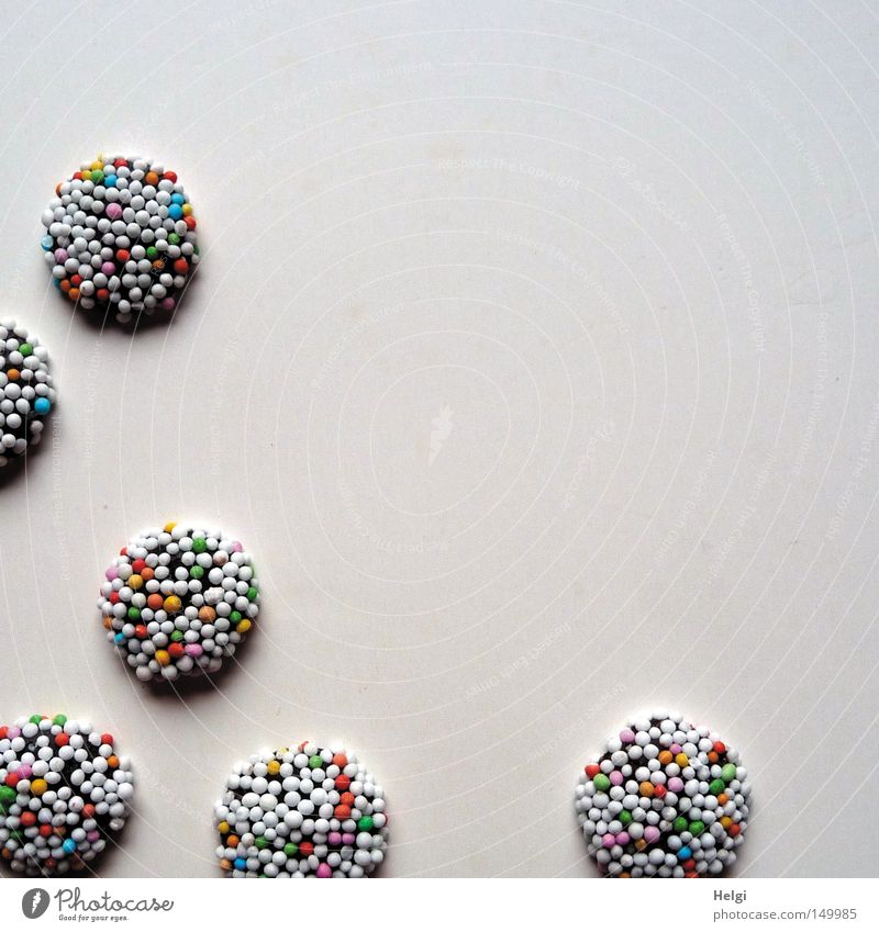 small chocolate candies with colourful sugar sprinkles on white background Candy Sweet Chocolate Granules Sugar Coulored sugar candy Sphere Delicious Nutrition