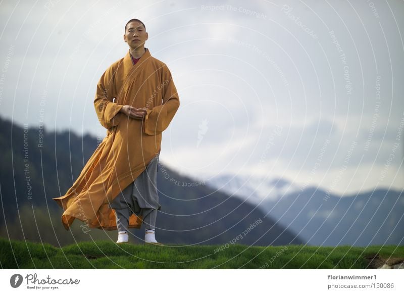 Shaolin monk in the wind - the face Chinese martial art Religion and faith Monk Meditation Wind Mountain Austria Vantage point Nature Peace