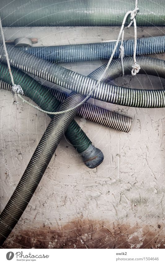 It hoses Wall (barrier) Wall (building) Facade Hose Fire department Fire-fighting tube Water hose Metal Plastic Hang Old Together Long Gloomy Many Calm sag Rope