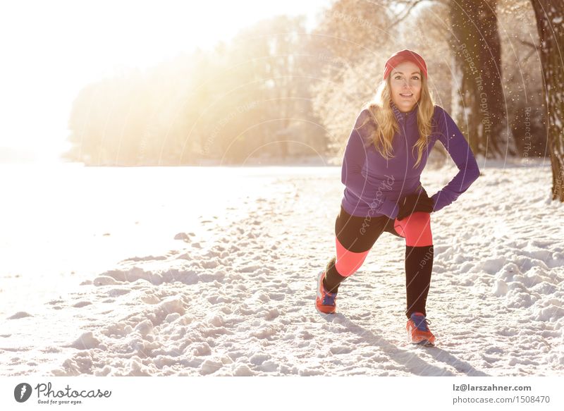 Active young woman exercising outdoors Sun Winter Snow Sports Woman Adults 1 Human being 30 - 45 years Snowfall Park Lake Clothing Blonde Fitness Smiling Action