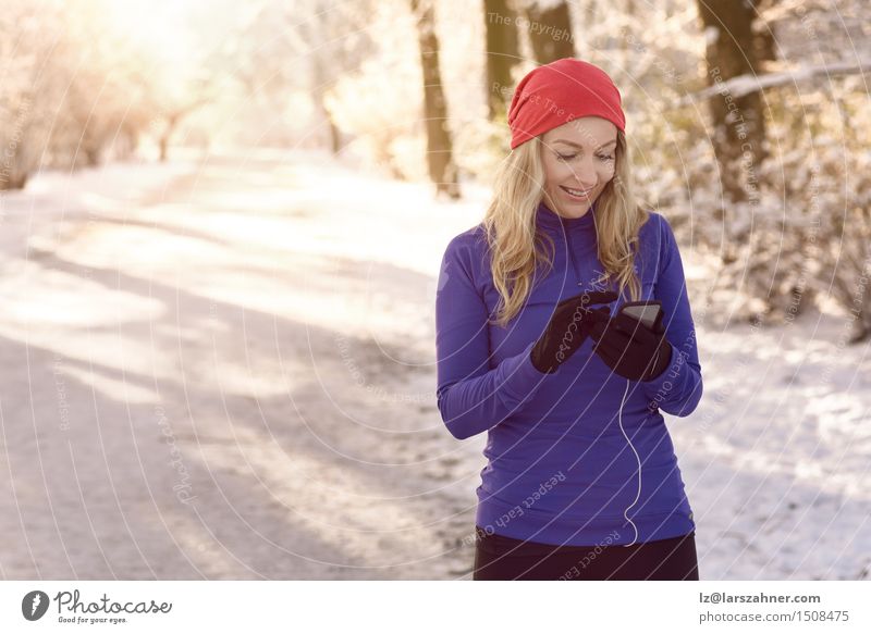 Woman checking her mobile phone Lifestyle Face Winter Business Telephone PDA Adults 1 Human being 30 - 45 years Park Lanes & trails Blonde Fitness cellphone