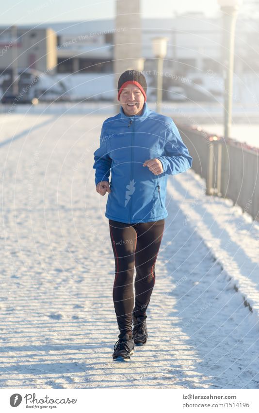 Man jogging in winter clothing Lifestyle Face Winter Snow Sports Jogging Adults 30 - 45 years Newspaper Magazine Park Street Fitness Determination Action
