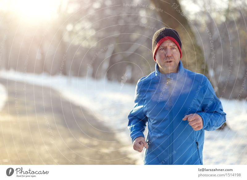 Man jogging in winter clothing Lifestyle Face Winter Snow Sports Jogging Adults 30 - 45 years Newspaper Magazine Park Street Breathe Fitness Determination