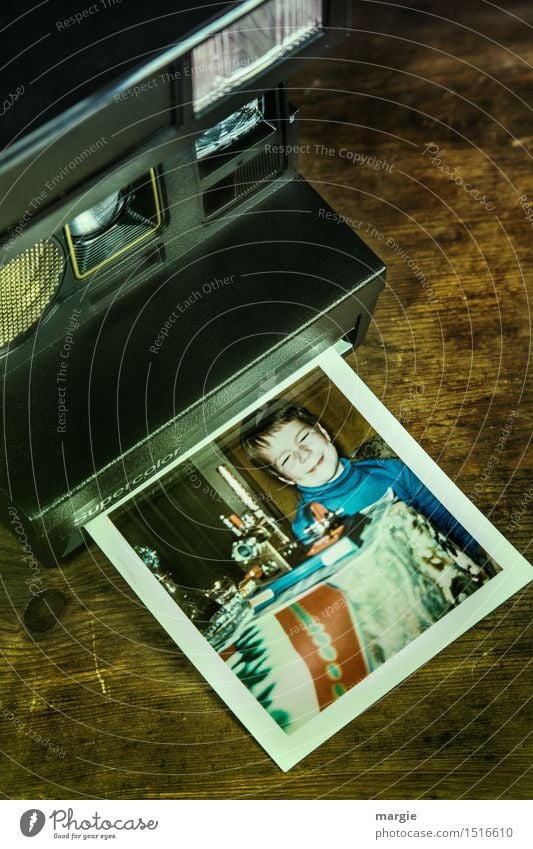 An old analogue camera with the photo of a little boy who is looking forward to his presents for Christmas Playing Human being Masculine Child Boy (child) 1