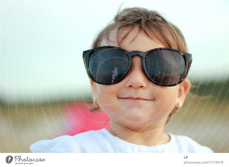 child wearing glasses looking curious at the camera and smiling Lifestyle Joy Well-being Leisure and hobbies Vacation & Travel Feasts & Celebrations Parenting