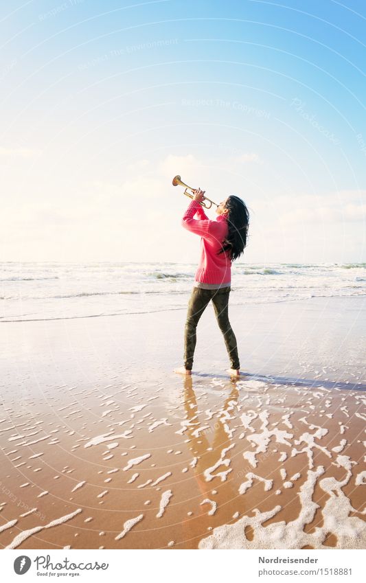 Young woman with a trumpet on the beach - a Royalty Free Stock ...