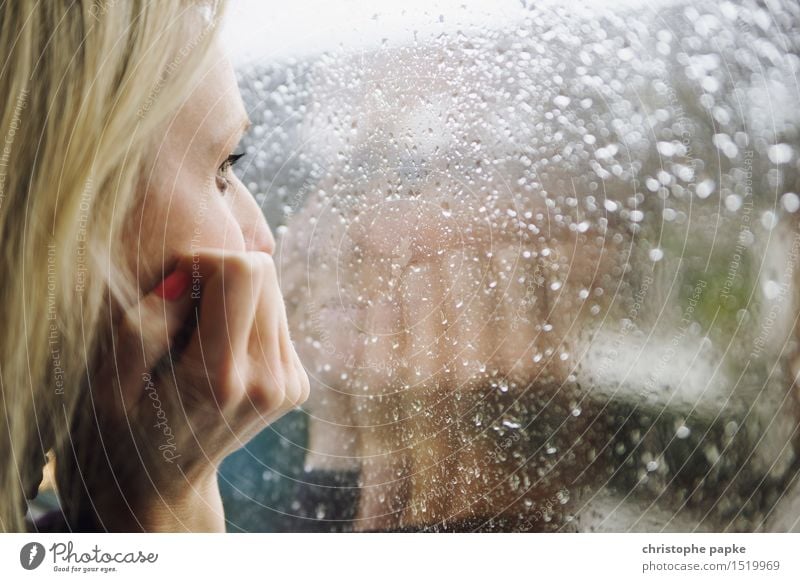 Blonde woman looking out window with raindrops on window pane Mascara Flat (apartment) Young woman Woman Face Hand Human being 30 - 45 years Adults Bad weather
