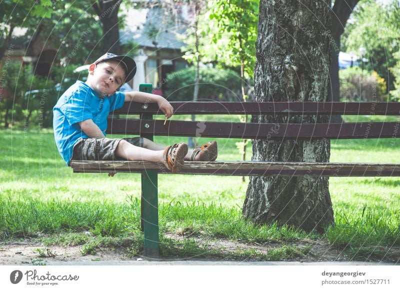 Little boy on a bench in the park Lifestyle Joy Happy Summer Child Human being Boy (child) Infancy Nature Autumn Park Sit Small Cute Bench eat kid young