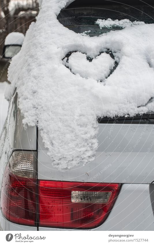 Snow heart shape on car. Winter Car Heart Love Happiness White Romance ice cold Symbols and metaphors Frost romantic window drawing background glass Frozen