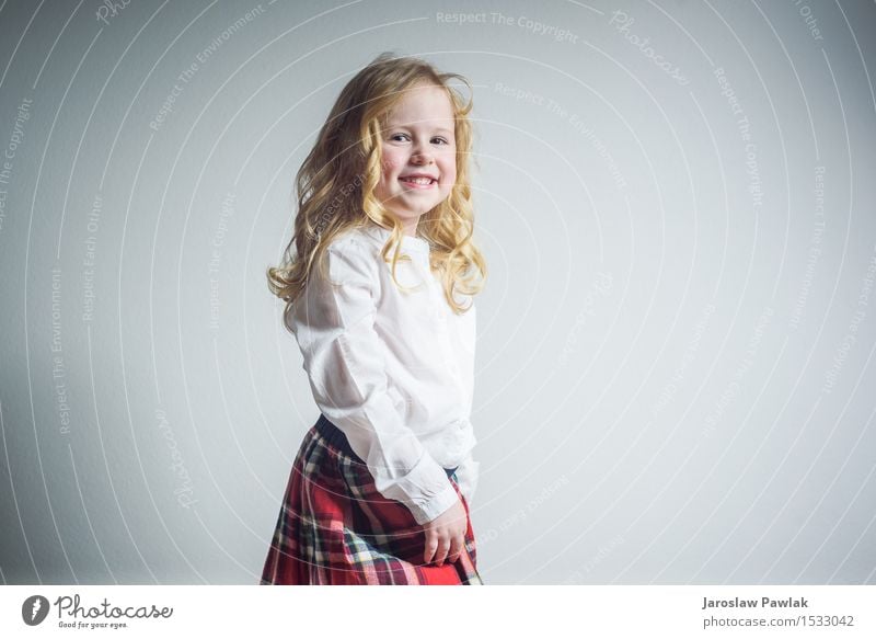 Beautiful smiling blond girl in a school uniform Lifestyle Joy Happy Face Child School Human being Woman Adults Infancy Youth (Young adults) Hand Blonde Smiling