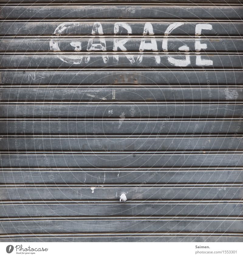 valuable label Facade Old Garage Garage door Doorknob Disk Lettering Letters (alphabet) Characters Structures and shapes Line Colour photo Subdued colour